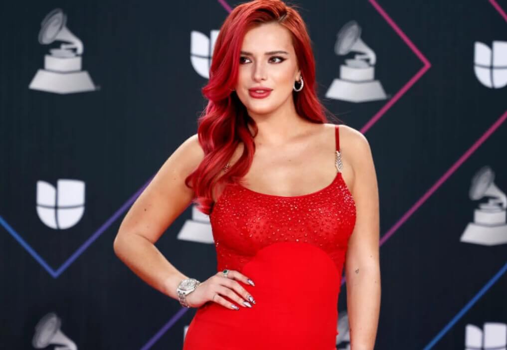 Bella Throne with red hair in a red dress